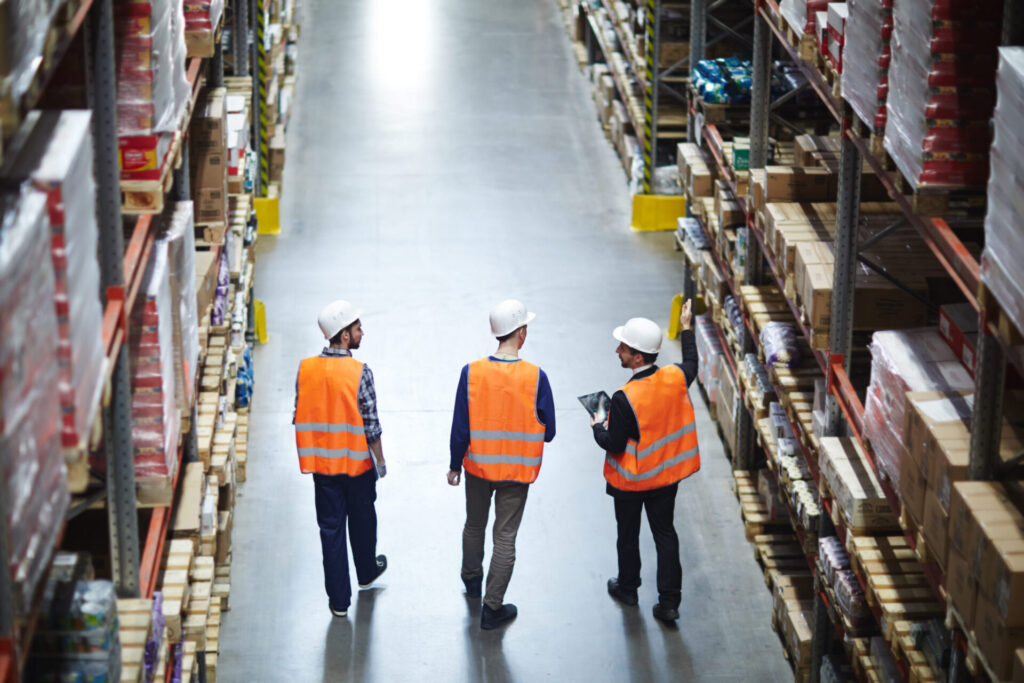Men walking through warehouse